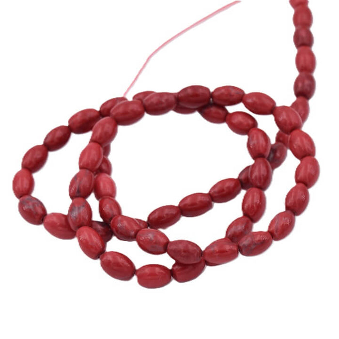 Perle ovale grain de riz - howlite teinté rouge 6x4mm (1 fil-39cm)